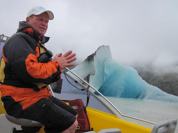 Gerry Lemon Glacier Explorers guide explaining to passengers the dynamics of the newly arrived iceberg